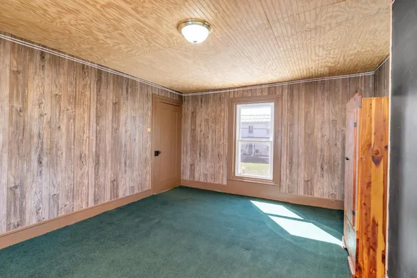a living room with furniture a dining table and chairs with wooden floor