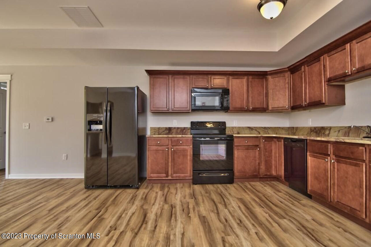 135 Bianca Way Old Forge, PA 18518 - Photo 4 of 11 a kitchen with a refrigerator sink and wooden cabinets