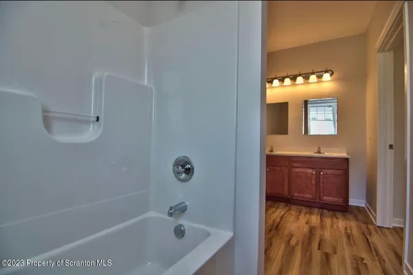 a bathroom with a sink a mirror and a bathtub