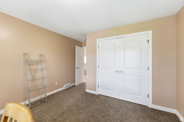 7235 Viansa Court Midvale, UT 84047 - Photo 24 of 43 Unfurnished bedroom with dark carpet and a closet