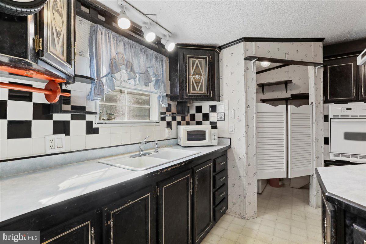 111 North Fairfax Boulevard Ranson, WV 25438 - Photo 11 of 32 a kitchen with stainless steel appliances a sink and cabinets