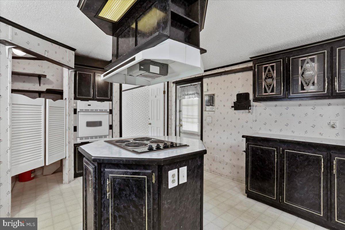 111 North Fairfax Boulevard Ranson, WV 25438 - Photo 12 of 32 a kitchen with stainless steel appliances kitchen island a stove and a refrigerator