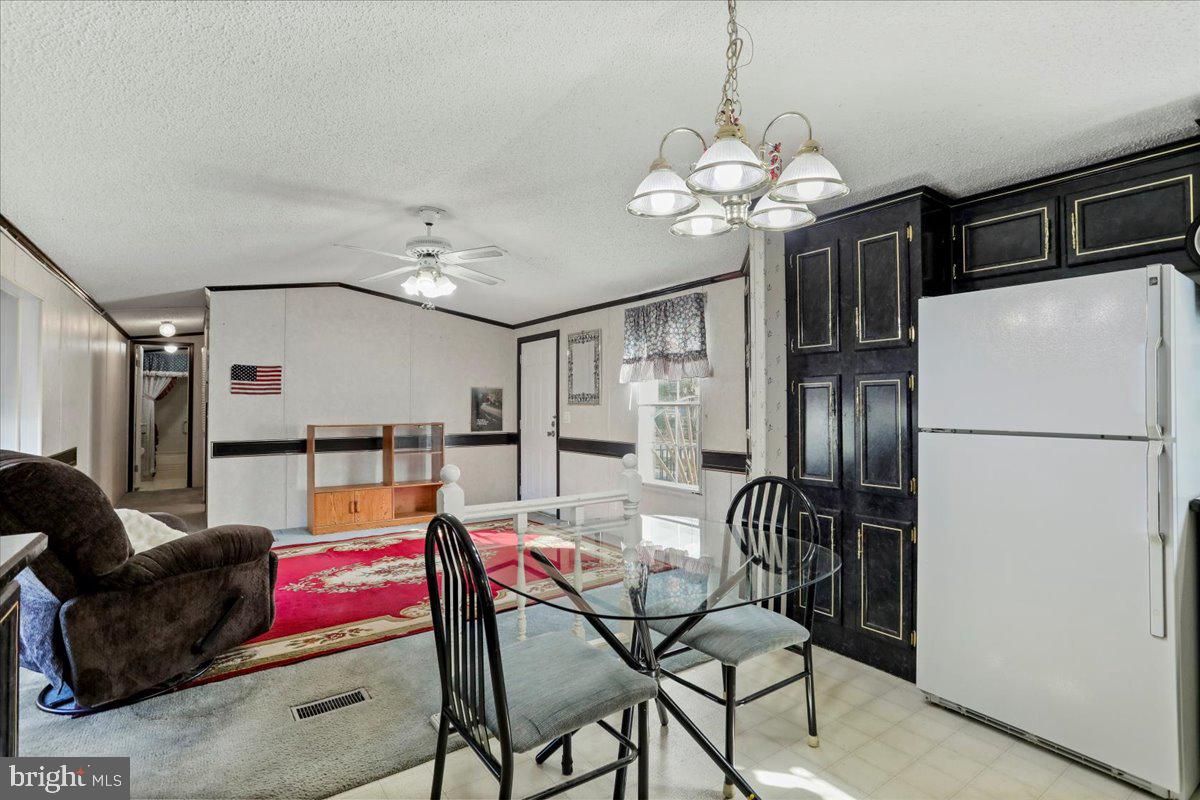 111 North Fairfax Boulevard Ranson, WV 25438 - Photo 15 of 32 a dining room with furniture and a chandelier
