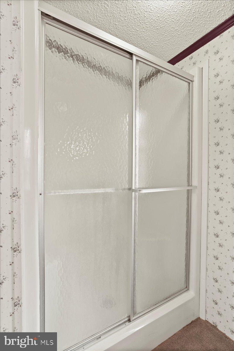 111 North Fairfax Boulevard Ranson, WV 25438 - Photo 21 of 32 a bathroom with a glass shower door