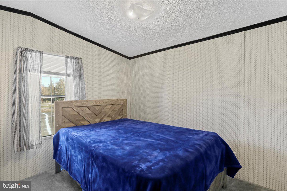 111 North Fairfax Boulevard Ranson, WV 25438 - Photo 24 of 32 a bed sitting in a bedroom next to a bathroom