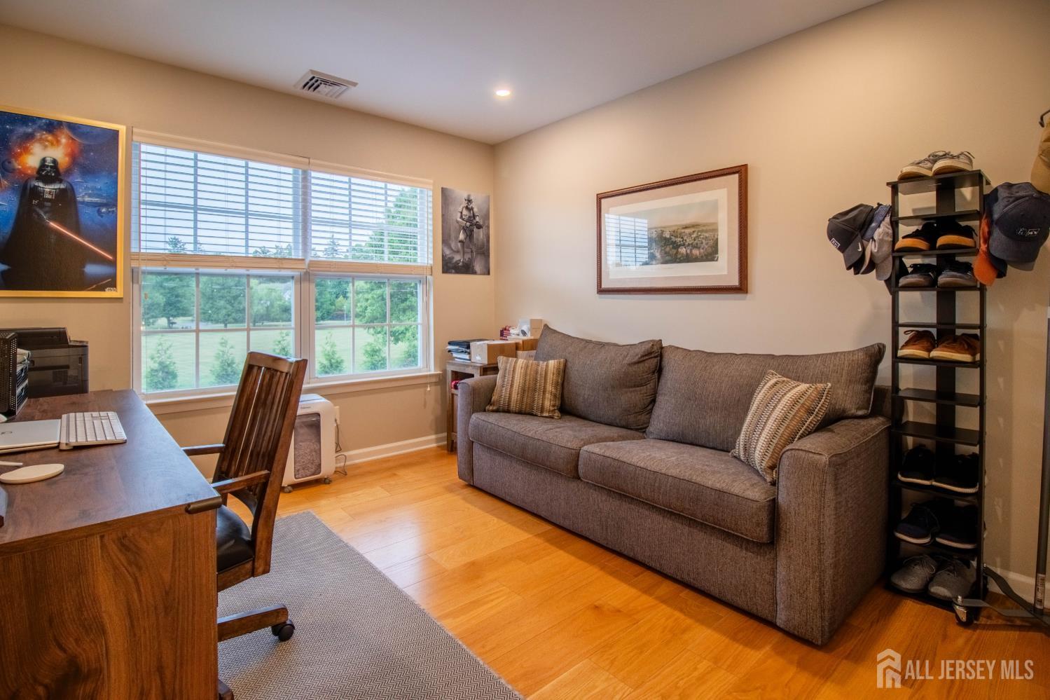 9 Pondview Drive Tinton Falls, NJ 07724 - Photo 21 of 41 a living room with furniture and a flat screen tv