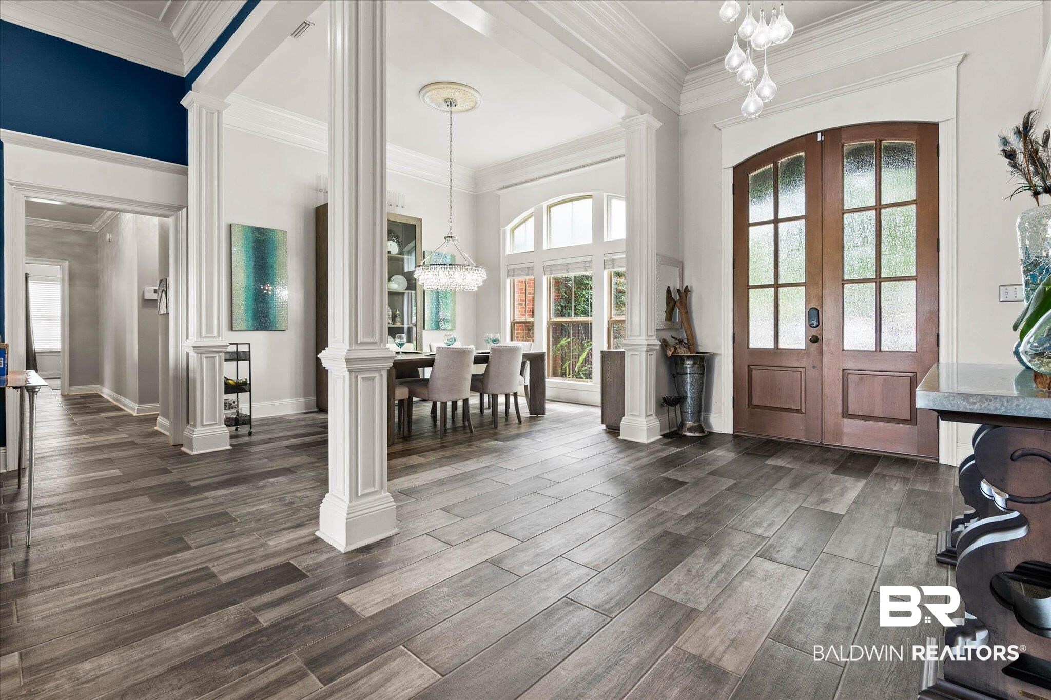 24908 Bosbyshell Avenue Daphne, AL 36526 - Photo 21 of 49 Grand entry foyer featuring wood-look tile flooring, substantial architectural columns, and a double arch-top entry door with privacy glass