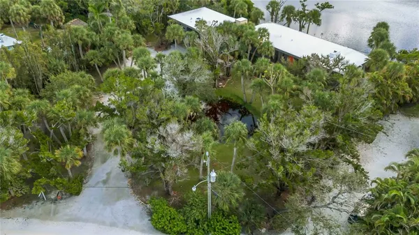 an aerial view of a house with a yard