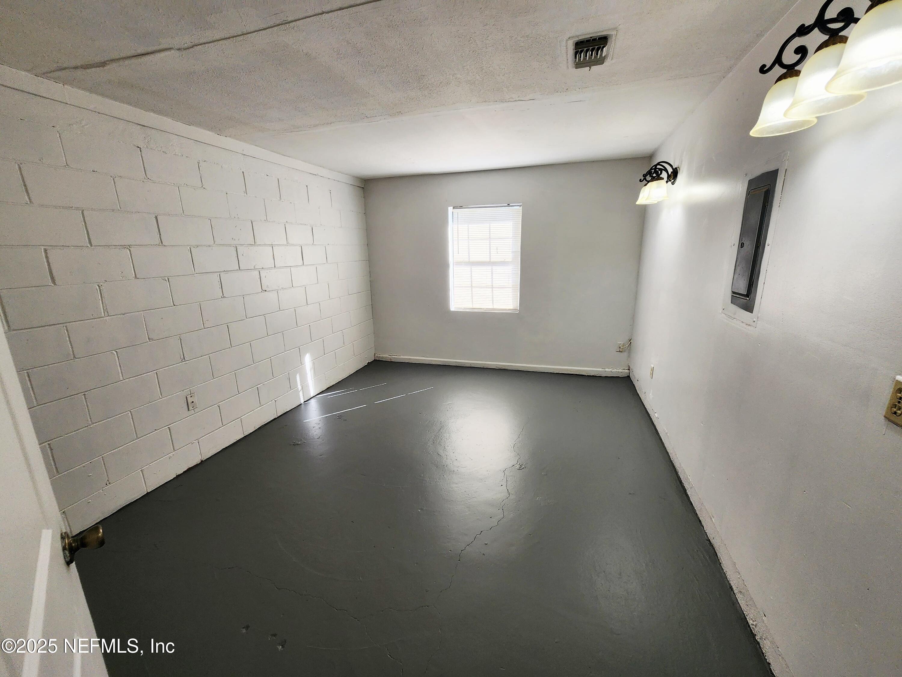 7127 Prellie Street Jacksonville, FL 32210 - Photo 13 of 16 an empty room with a window