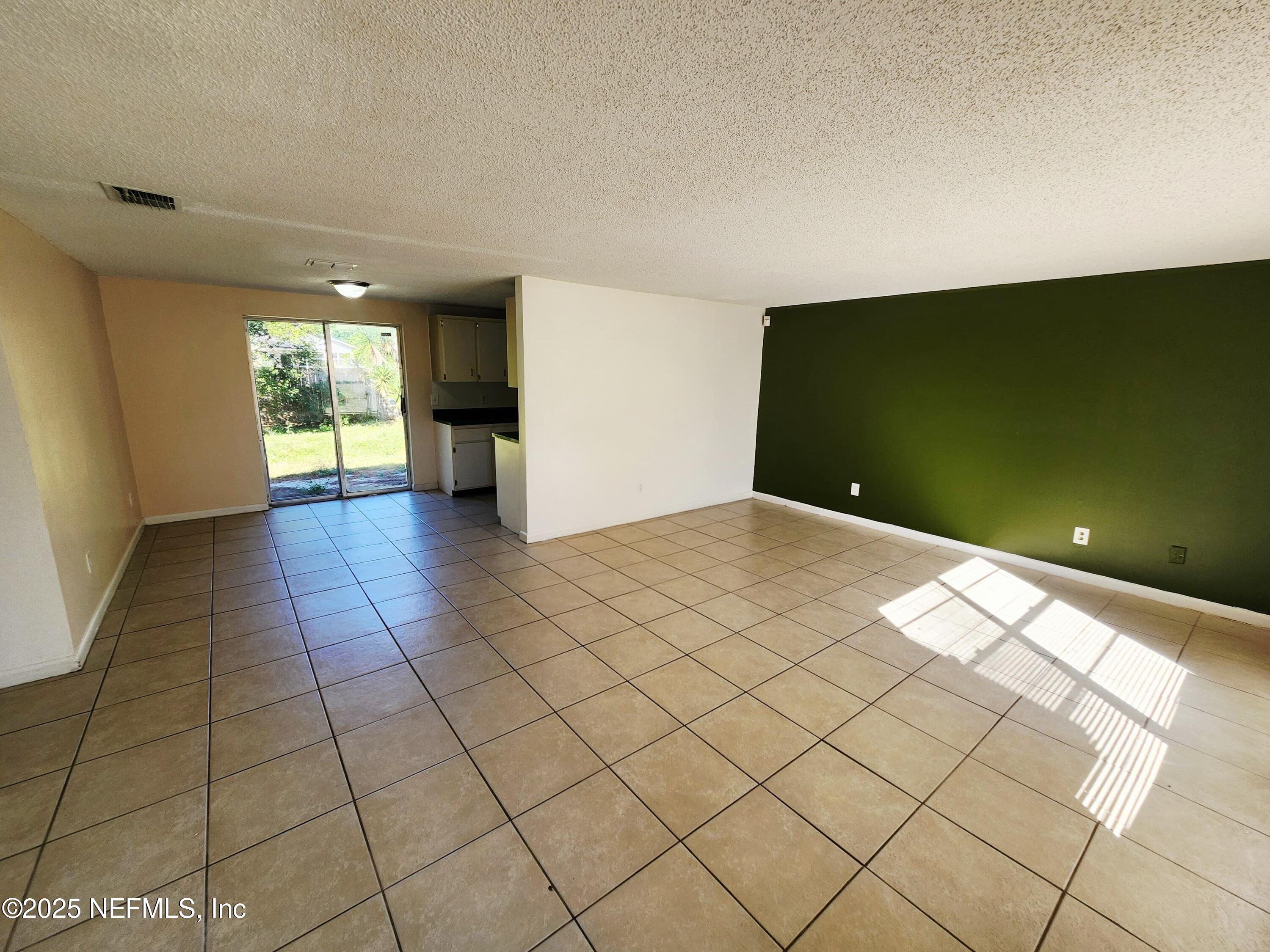 7127 Prellie Street Jacksonville, FL 32210 - Photo 2 of 16 a view of empty room with wooden floor