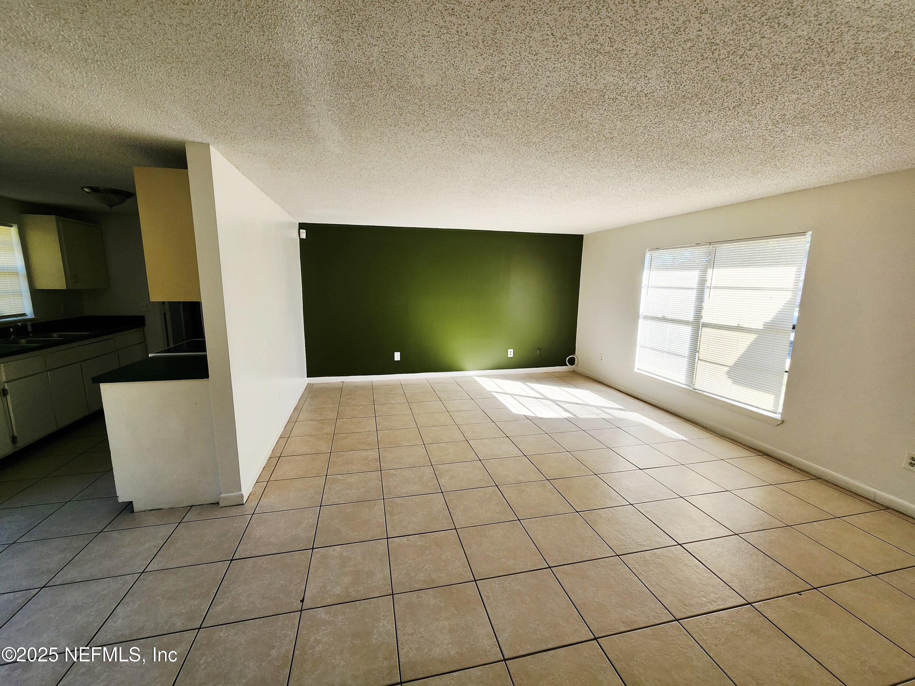 7127 Prellie Street Jacksonville, FL 32210 - Photo 3 of 16 a view of an empty room with a window