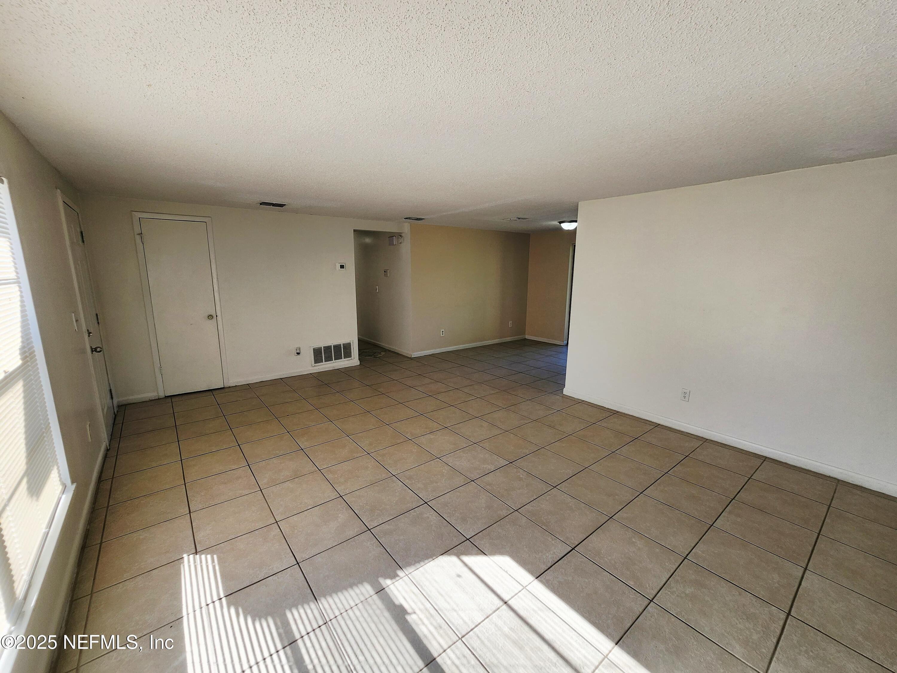 7127 Prellie Street Jacksonville, FL 32210 - Photo 4 of 16 a view of an empty room and window