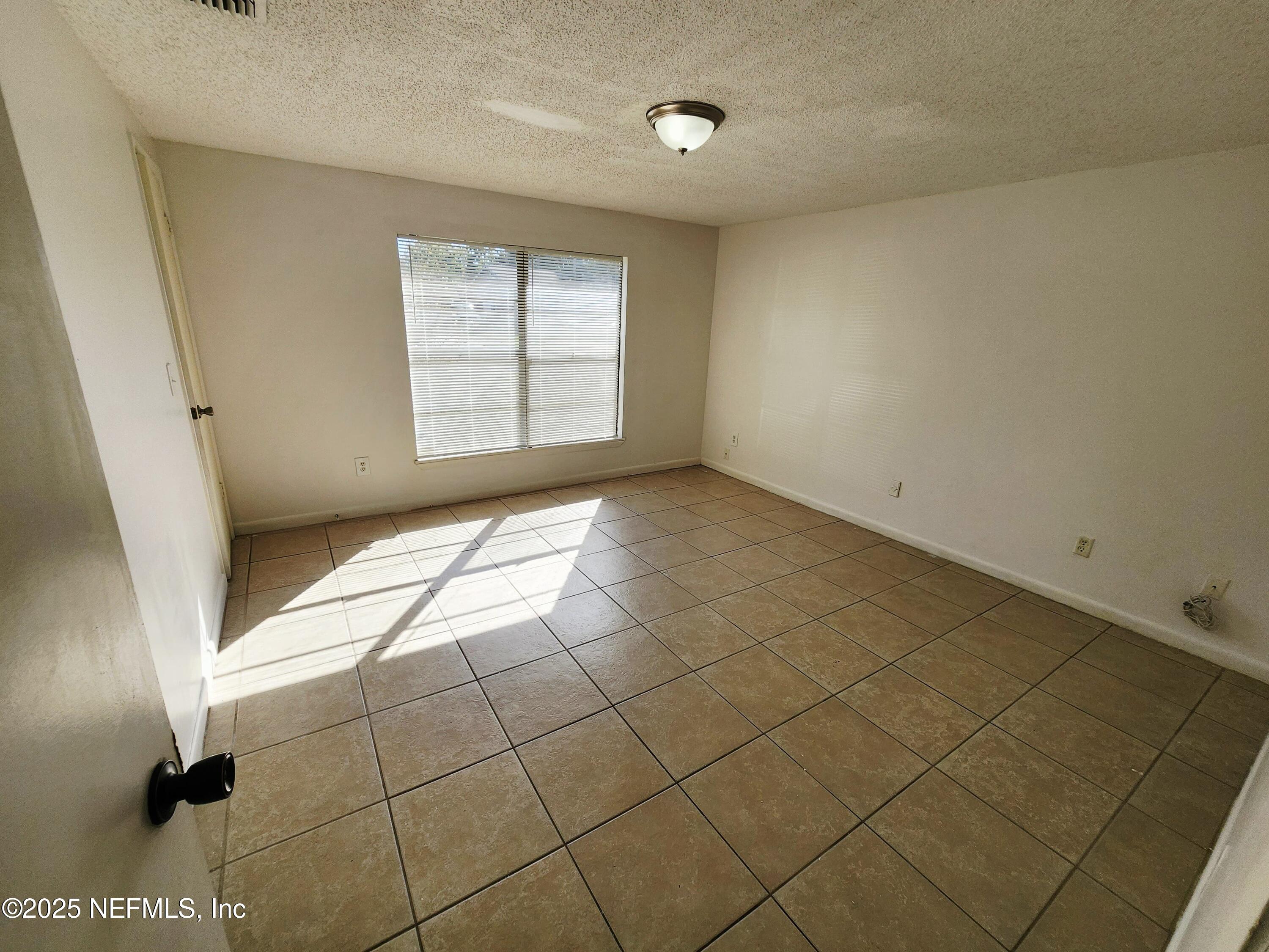 7127 Prellie Street Jacksonville, FL 32210 - Photo 10 of 16 a view of an empty room and a window