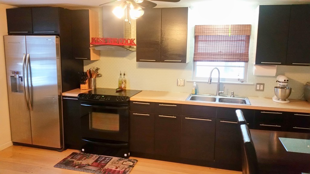 237 Draper Street Springfield, MA 01108 - Photo 5 of 30 a kitchen with a sink refrigerator and microwave
