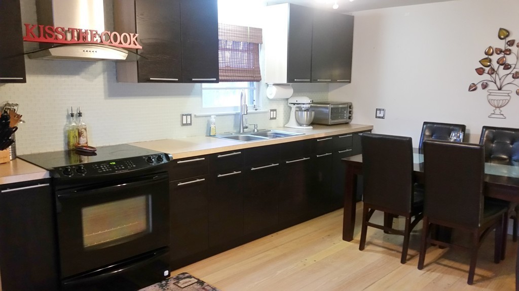 237 Draper Street Springfield, MA 01108 - Photo 6 of 30 a kitchen with a sink cabinets and wooden floor