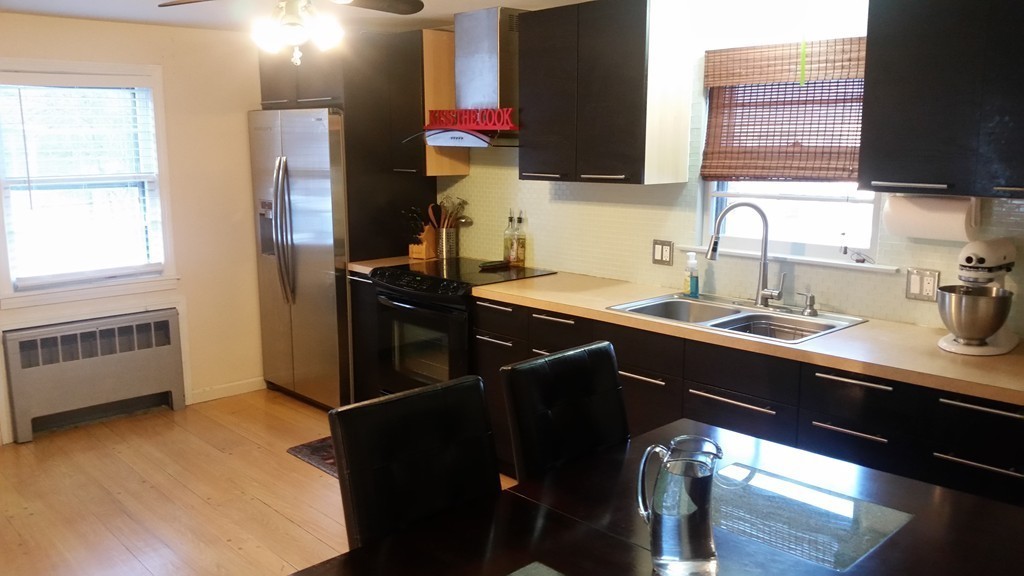237 Draper Street Springfield, MA 01108 - Photo 7 of 30 a kitchen with a sink appliances and cabinets