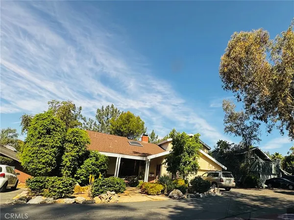 a view of a house with a yard and a garden