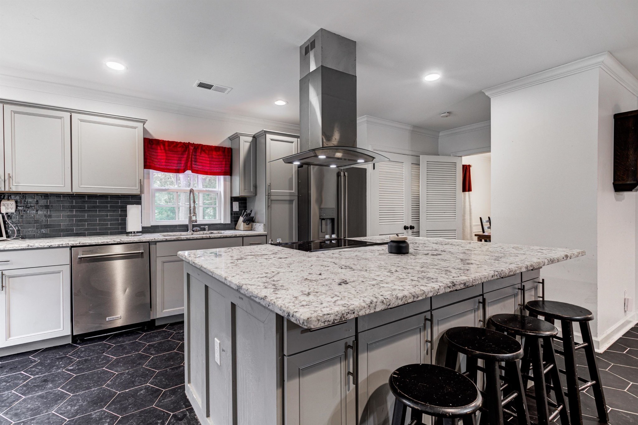 8929 Rocky Point Road Cordova, TN 38018 - Photo 11 of 37 a kitchen with a sink a stove and chairs