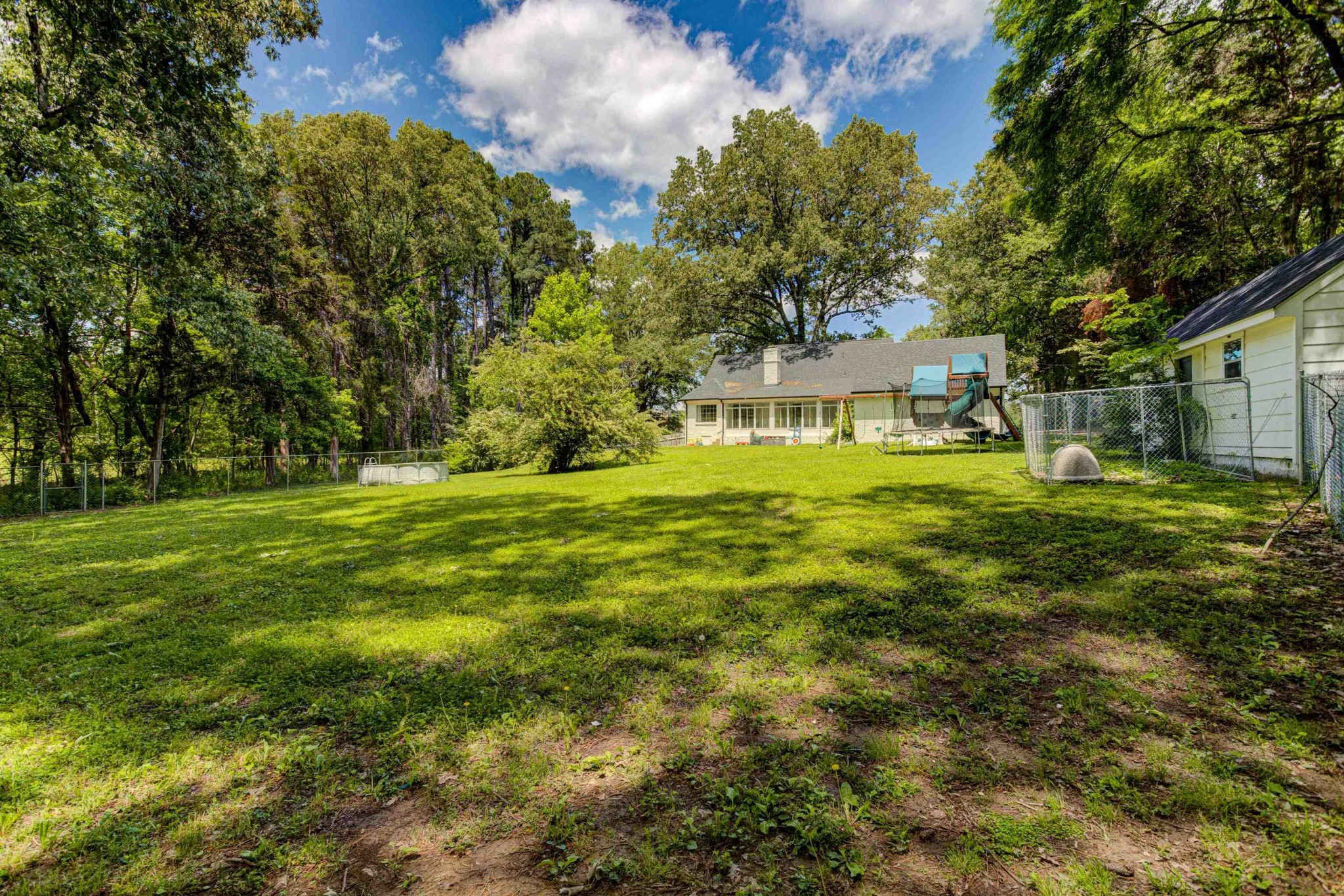 8929 Rocky Point Road Cordova, TN 38018 - Photo 32 of 37 a view of a big yard with plants and large trees
