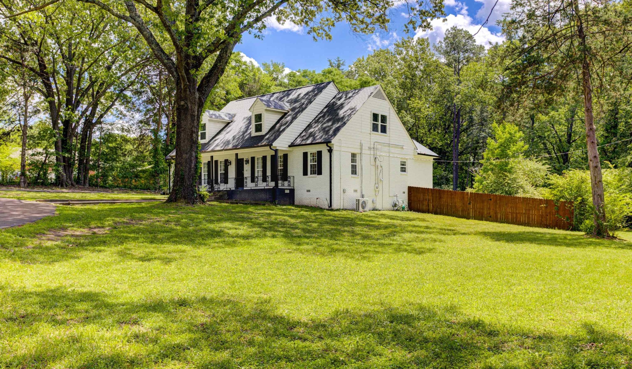 8929 Rocky Point Road Cordova, TN 38018 - Photo 36 of 37 a view of a house with a big yard and large trees