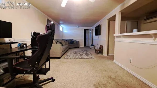 a view of a livingroom with workspace and a window