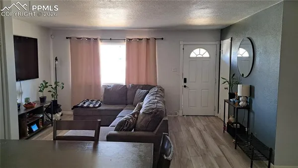 a living room with furniture and a flat screen tv