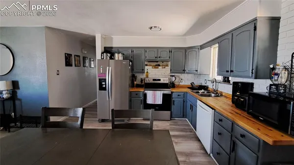 a kitchen with stainless steel appliances granite countertop a refrigerator sink and cabinets