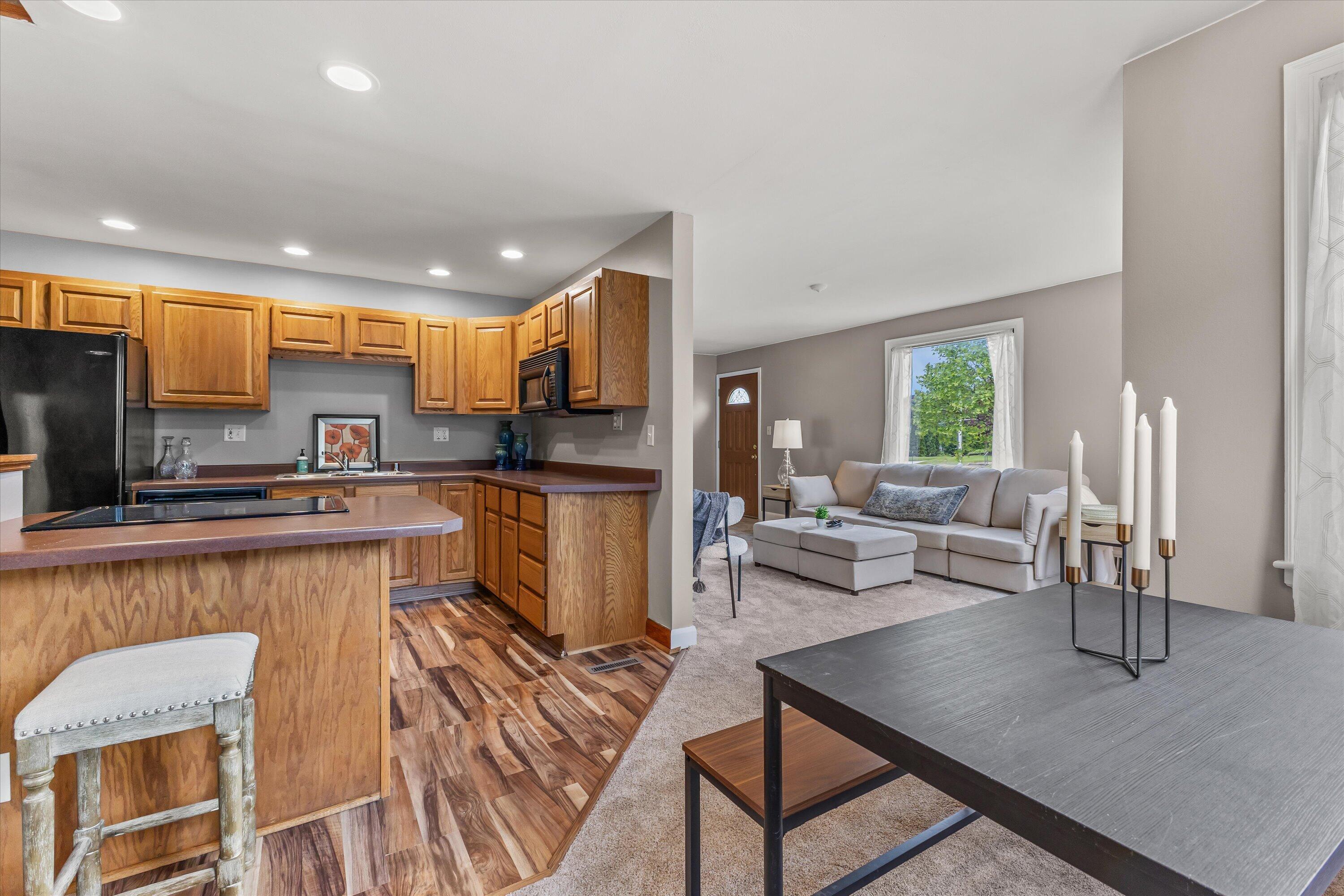 2925 North Main Street Racine, WI 53402 - Photo 5 of 23 An inviting layout seamlessly connects the kitchen, dining, and living spaces—perfect for entertaining guests or enjoying everyday life.