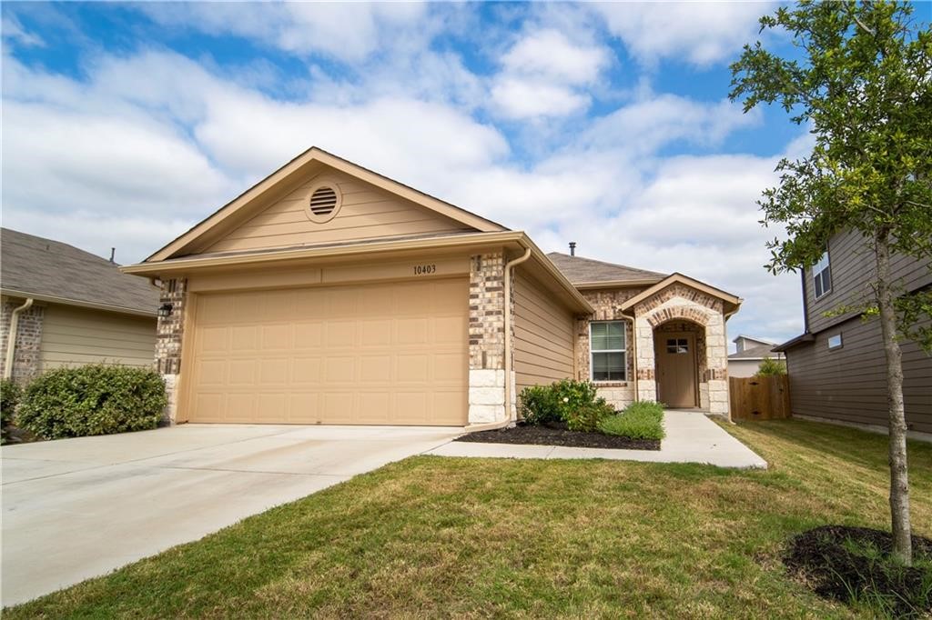 a front view of a house with a yard and garage