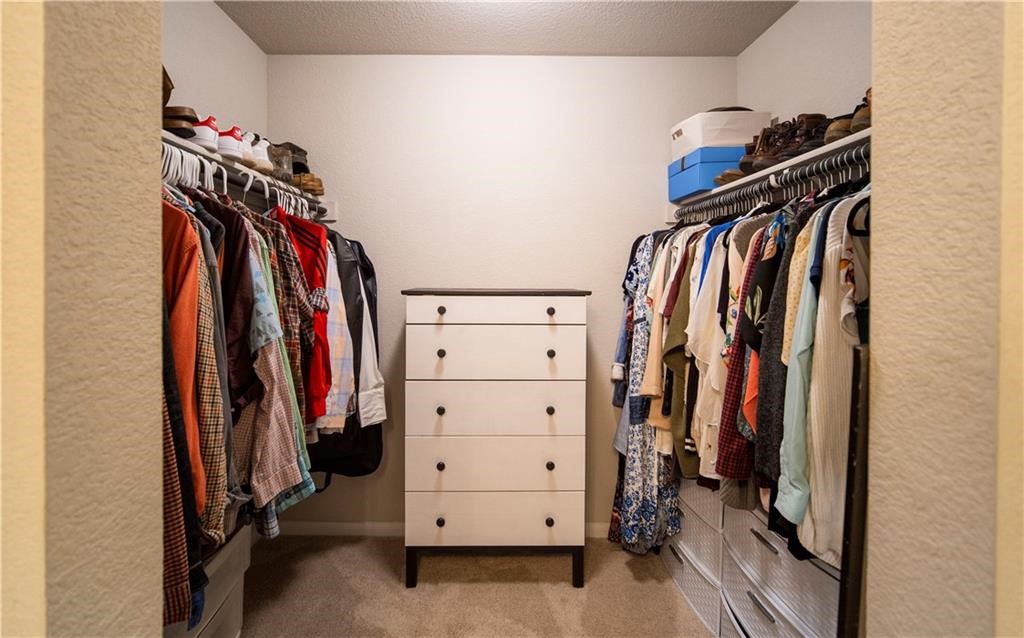 10406 Hatton Lane Austin, TX 78754 - Photo 14 of 22 a view of walk in closet with clothes
