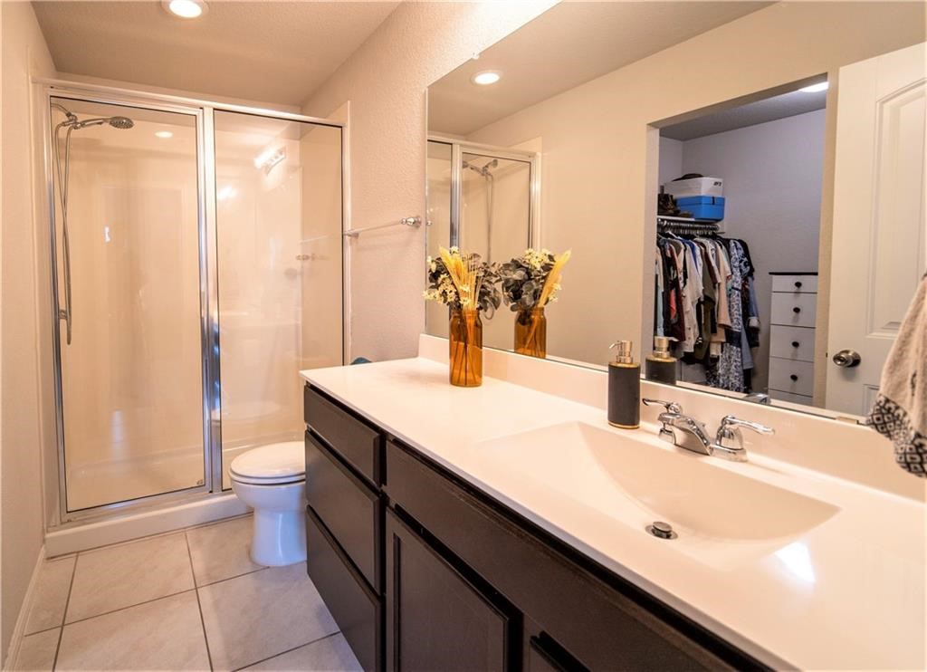 10406 Hatton Lane Austin, TX 78754 - Photo 15 of 22 a bathroom with a double vanity sink toilet and a mirror