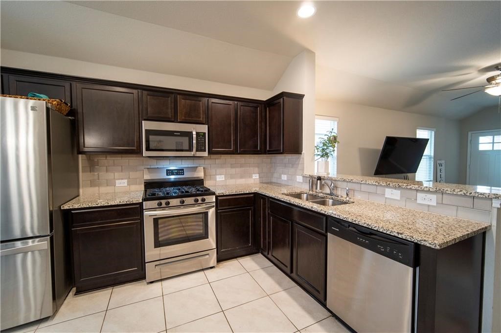 10406 Hatton Lane Austin, TX 78754 - Photo 5 of 22 a kitchen with a sink stove and refrigerator