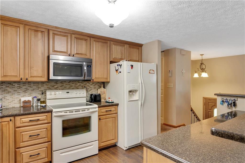227 Brewer Road Freedom, PA 15042 - Photo 11 of 34 a kitchen with stainless steel appliances granite countertop a refrigerator stove and sink