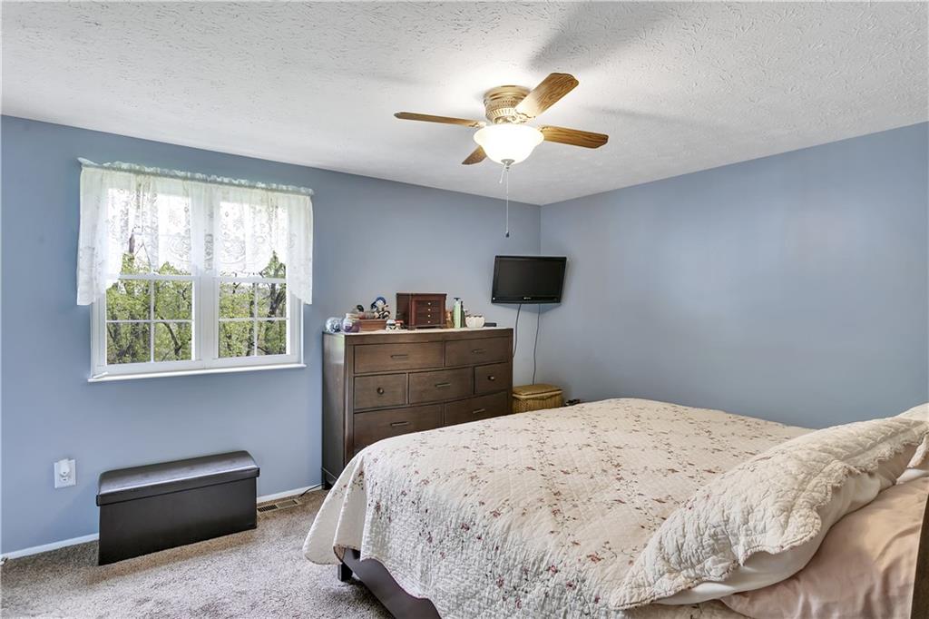 227 Brewer Road Freedom, PA 15042 - Photo 15 of 34 a bedroom with a bed and a chandelier