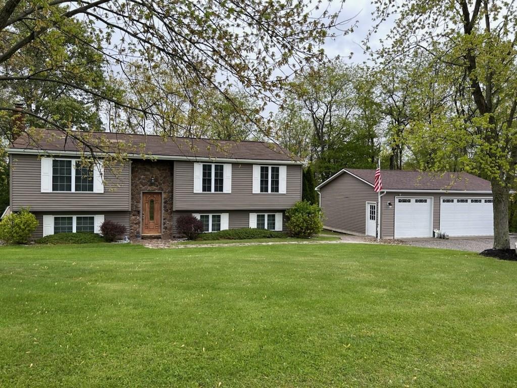 227 Brewer Road Freedom, PA 15042 - Photo 34 of 34 a front view of a house with a garden and trees