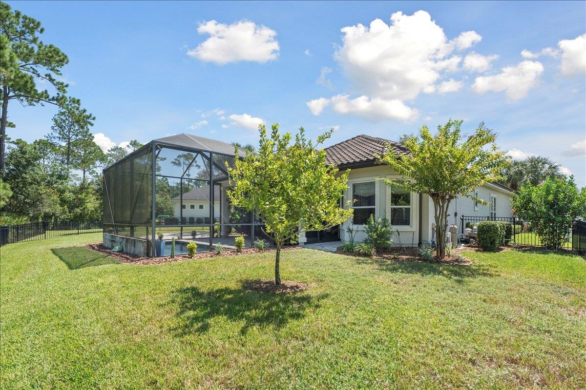 145 Paranza Trace St. Augustine, FL 32095 - Photo 25 of 34 a view of a house with a big yard and large trees