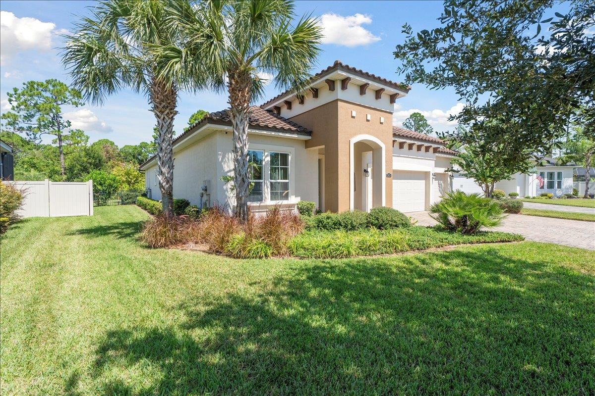 145 Paranza Trace St. Augustine, FL 32095 - Photo 3 of 34 a front view of a house with a garden