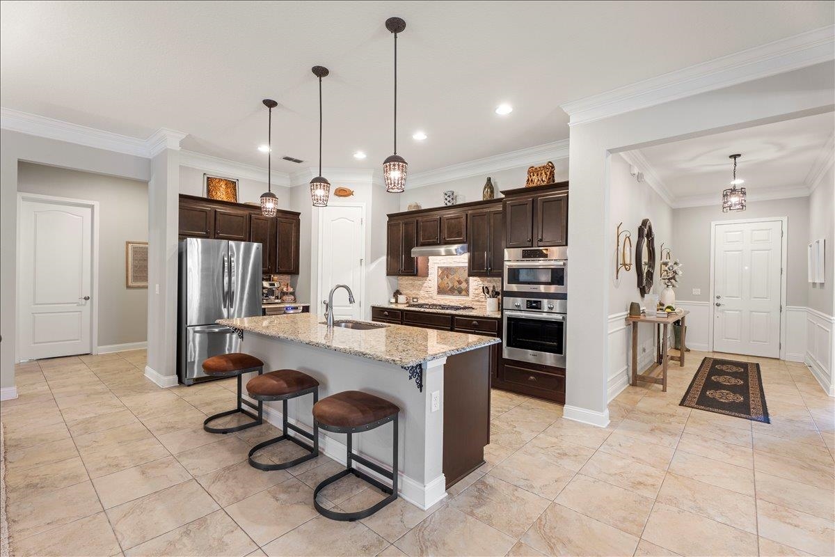145 Paranza Trace St. Augustine, FL 32095 - Photo 7 of 34 a kitchen with kitchen island a counter top space appliances and cabinets