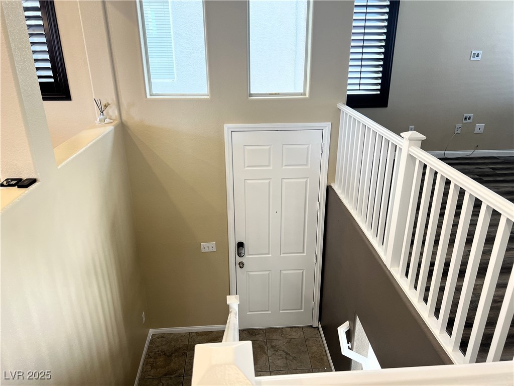 9535 Leaping Lizard Street Las Vegas, NV 89178 - Photo 28 of 37 Staircase from second floor looking down to front door access.