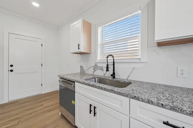 an empty room with wooden floor and ceiling fan