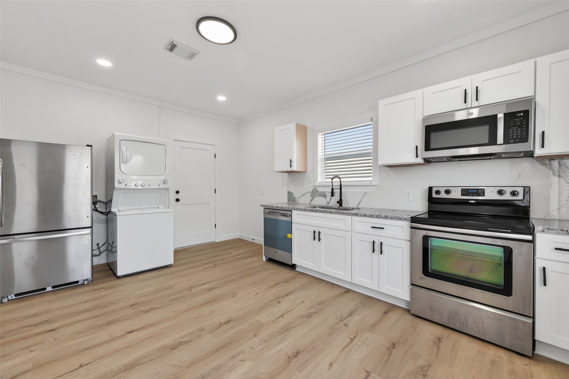 2202 Hutchins Street, Unit D Houston, TX 77003 - Photo 13 of 39 a kitchen with stainless steel appliances granite countertop a stove a sink and a microwave