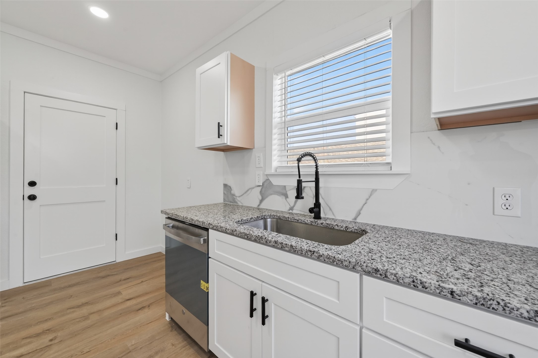 2202 Hutchins Street, Unit D Houston, TX 77003 - Photo 14 of 39 a kitchen with granite countertop white cabinets and a sink