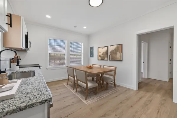 a dining room with furniture and wooden floor