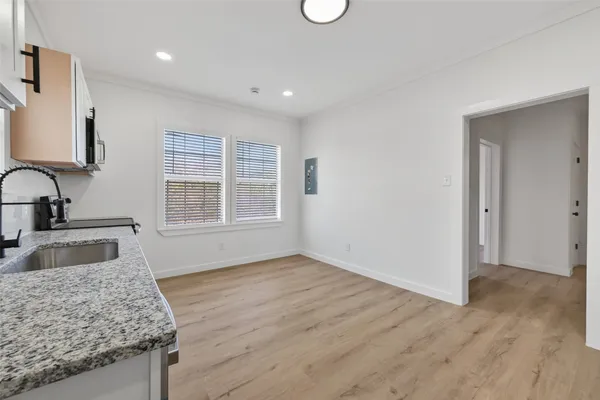 a bathroom with a granite countertop sink and mirror