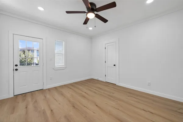 wooden floor in an empty room with a window