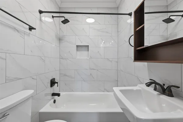 a bathroom with a sink a toilet and bathtub