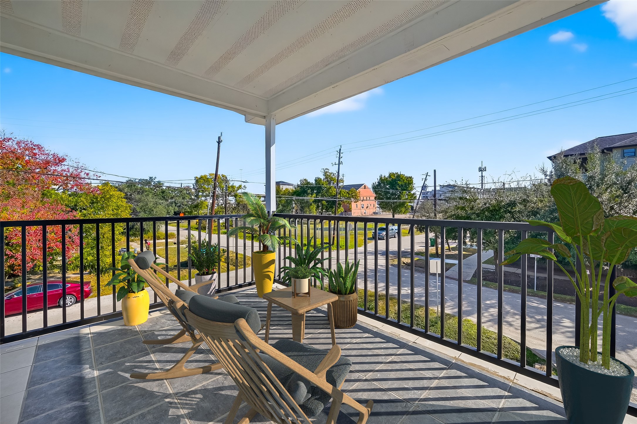 2202 Hutchins Street, Unit D Houston, TX 77003 - Photo 3 of 39 a view of a balcony with wooden chairs