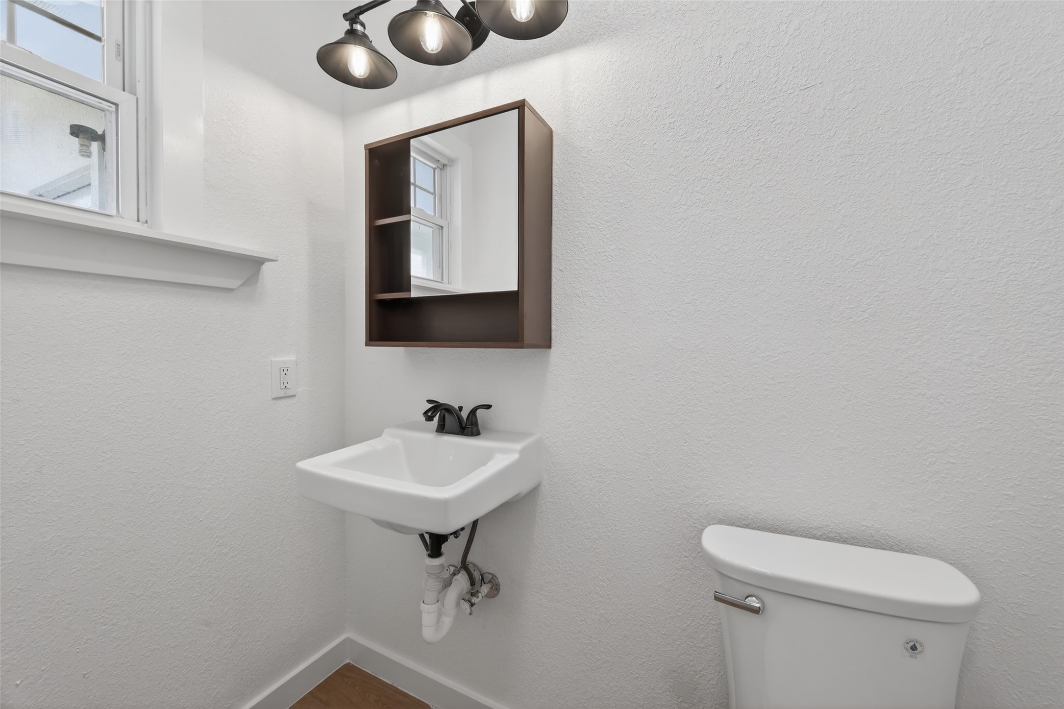 2202 Hutchins Street, Unit D Houston, TX 77003 - Photo 31 of 39 a bathroom with a toilet sink and mirror