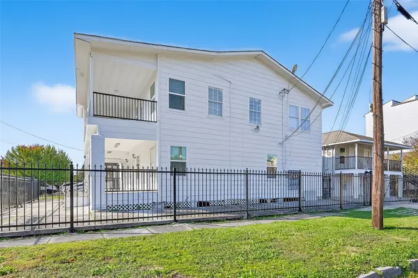 a view of a house with a yard and deck