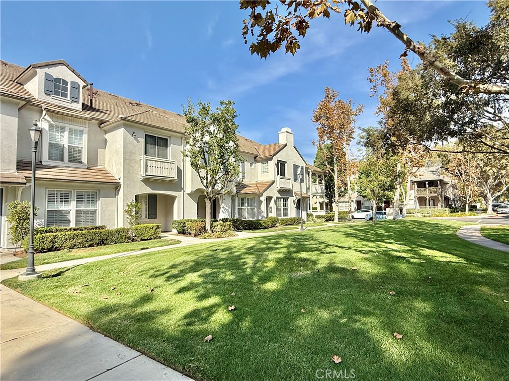 a front view of a building with a garden